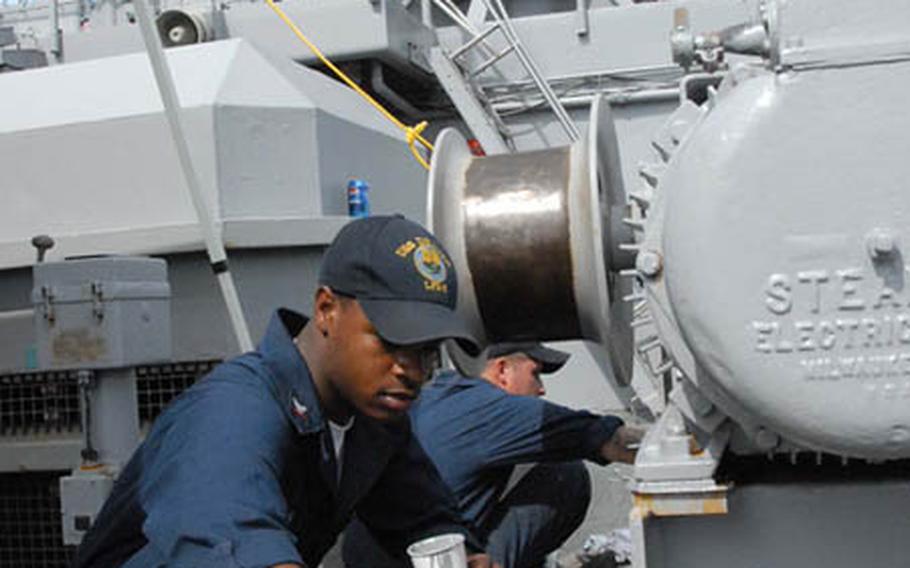 Petty Officer 3rd Class Dion Jones applies some paint to the USS Denver on Thursday at Sasebo Naval Base, Japan. The revitalized ship will replace the USS Juneau at Sasebo.