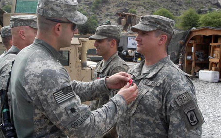 Spc. Jonathan Smiley receives one of the 48 Bronze Star Medals with valor that members of the 2nd Battalion, 503rd Infantry Regiment have earned during their tour in Afghanistan. Lt. Col Bill Ostlund’s battalion still has about a month in country before heading back to Vicenza, Italy.