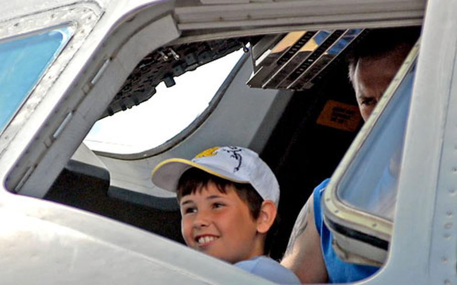 A youngster enjoys his chance to sit in the cockpit of a C-17 Globemaster III at the Berlin Airlift open House at Wiesbaden Army Airfield on Sunday.