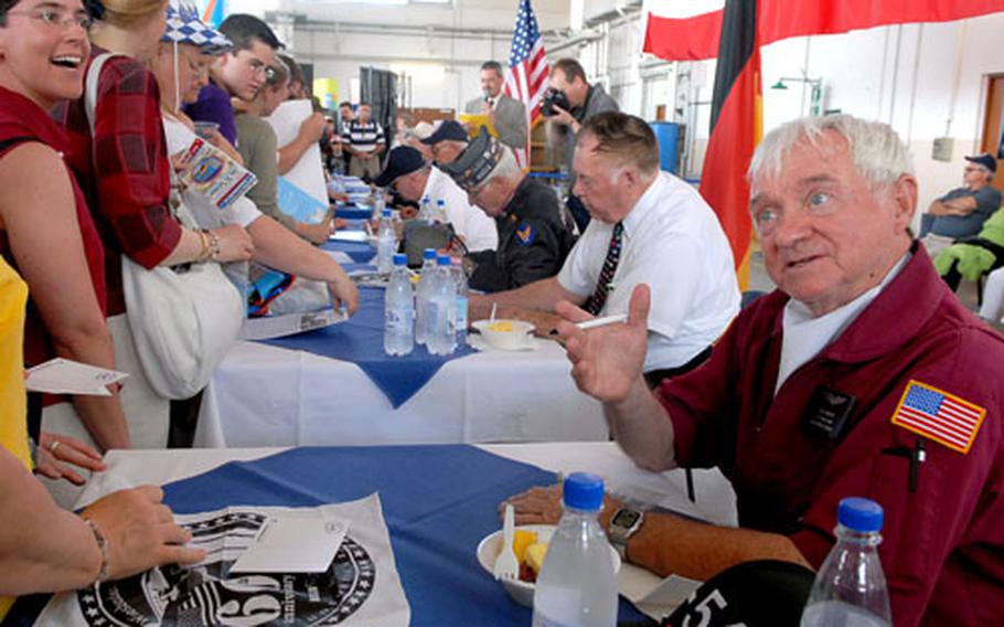 Berlin Airlift veteran William Morrissey, right, talks to visitors to the Wiesbaden Army Airfield Airlift Open House as he and other vets sigh autographs. They are (from right) Earl Moore, Johnny Macia, Lewis Whipple, Donald Measley and Gail Halvorsen.