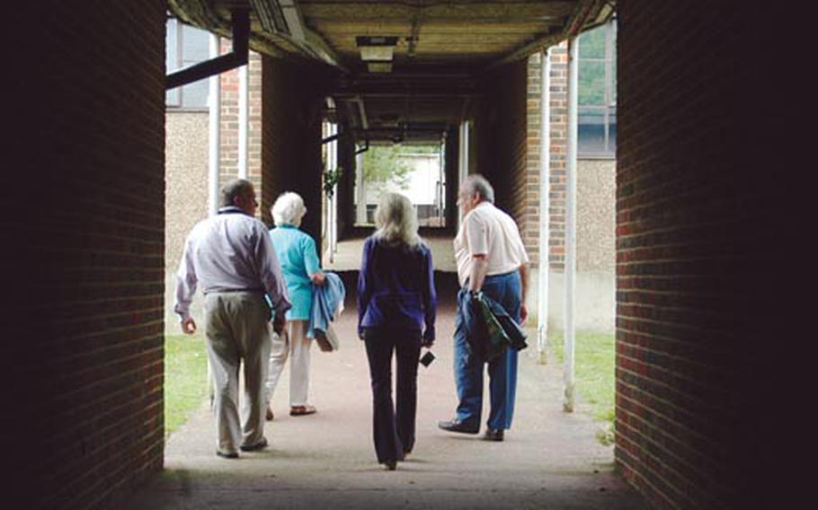 Former faculty members and alumni walk past abandoned classrooms in the vacant campus of London Central High School. Memories resurfaced as the small group toured the campus last week.