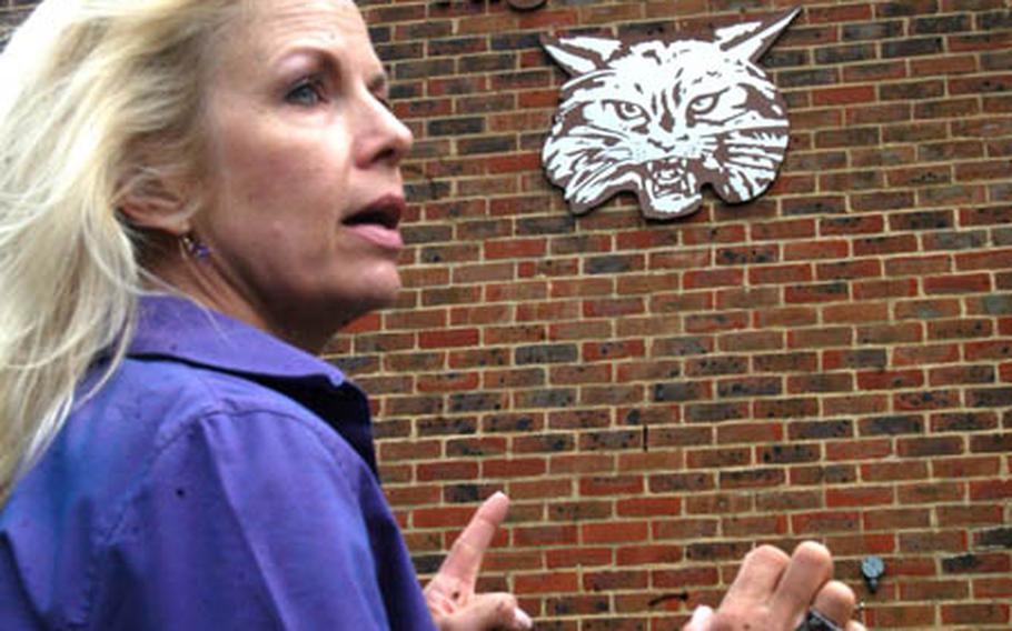 Susan Kazara Harper tells others how she discovered the image that became the latest London Central High school bobcat symbol while preparing student handbooks in the mid-1980s. Harper, a former secretary at the school, was part of a small group touring the campus last week.