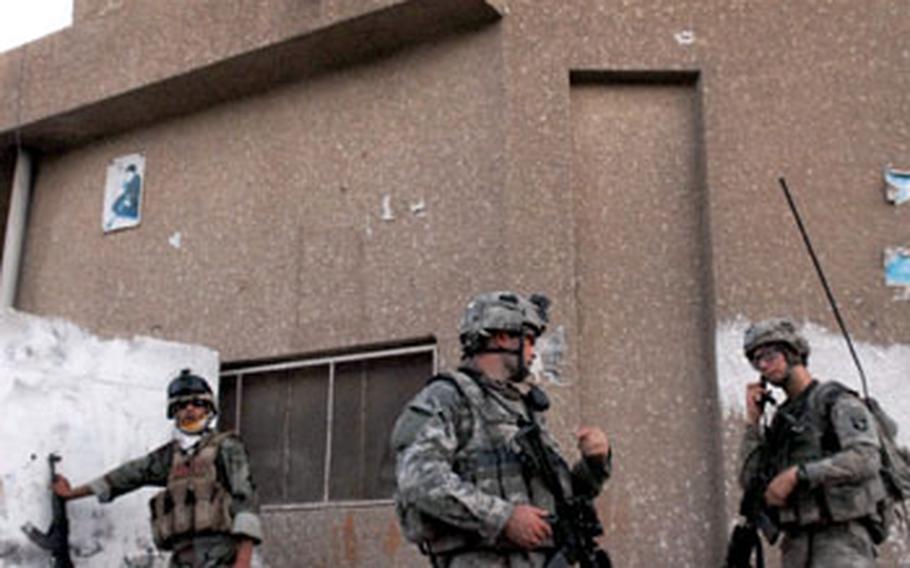 U.S. and Iraqi troops patrol in the northwest Baghdad neighborhood of Shula.