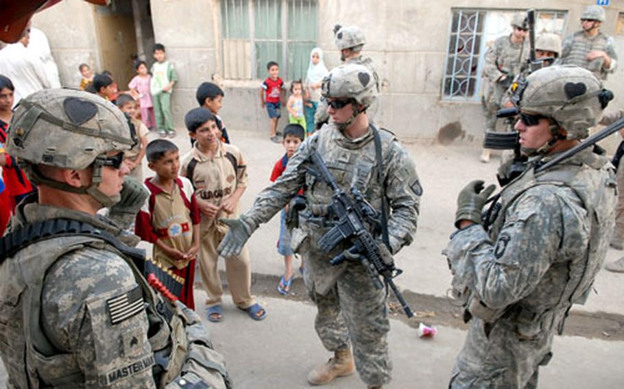 Staff Sgt. Robert Smith, far right, during a patrol in the northwest Baghdad neighborhood of Shula. Stepped up patrols by U.S. and Iraqi troops have brought the neighborhood under control since fighting erupted here in late March, soldiers say, but the poverty and lack of essential services that have long given militias an opening remain problematic.