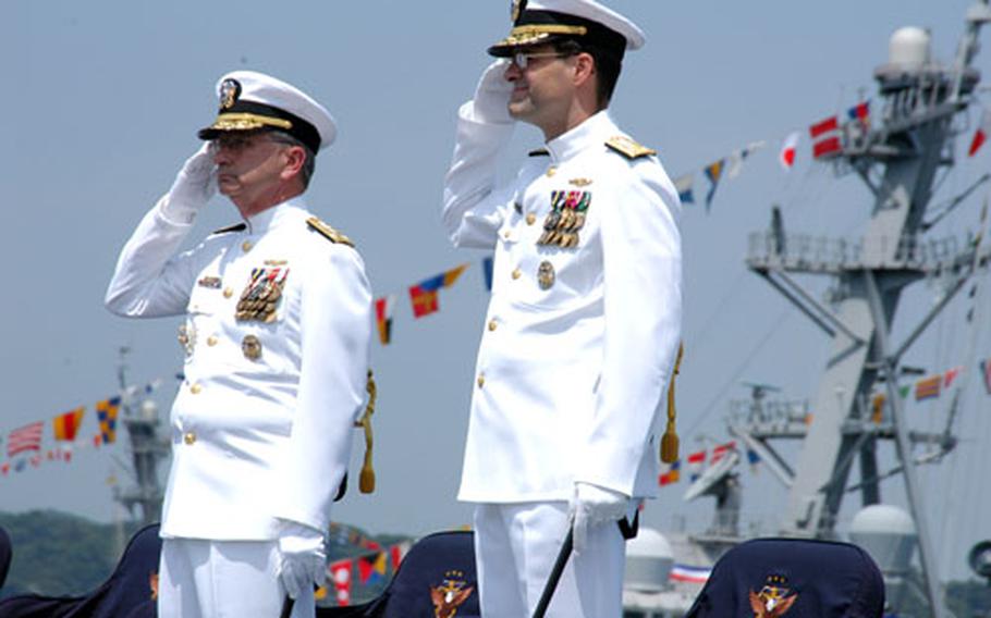 Vice Admirals Doug Crowder, left, and John Bird salute during the 7th Fleet Change of Command ceremony Saturday. Bird relieved Crowder in a well-attended event aboard the USS Blue Ridge.