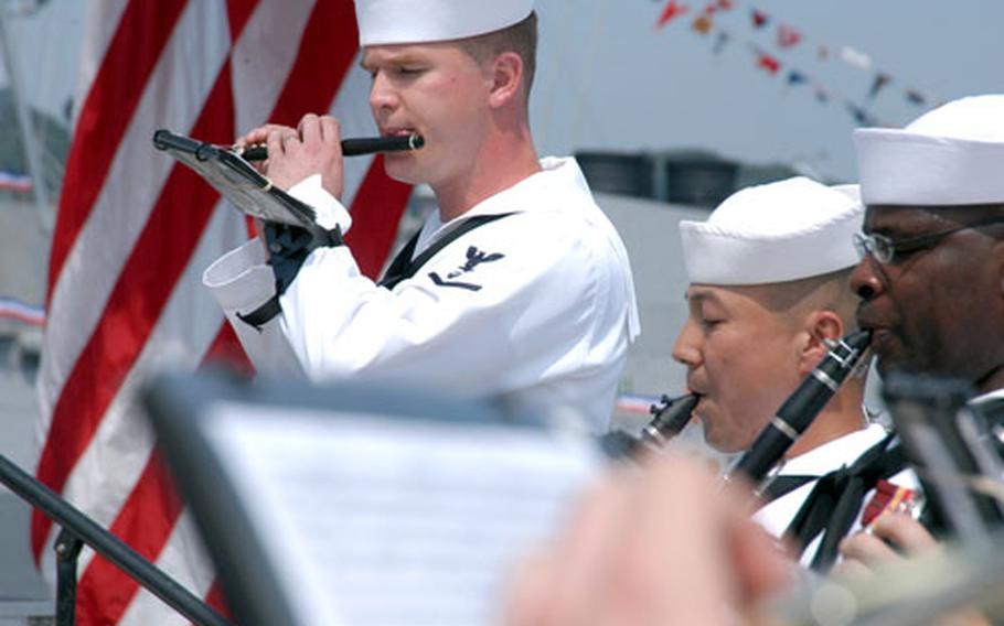 Petty Officer 3rd Class John Wylie, top left, plays the piccolo in the 7th Fleet band for the Change of Command ceremony Saturday.