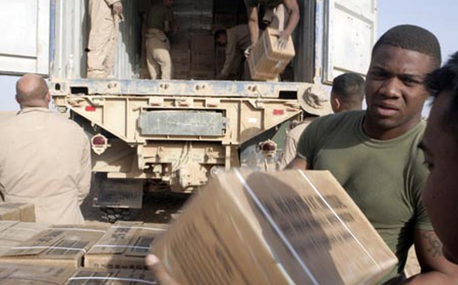 Marines and sailors with Marine Wing Support Squadron 172 unload Meals, Ready to Eat at Rapid Refueling Point San Francisco in the Jazirah Desert in Anbar province, Iraq.