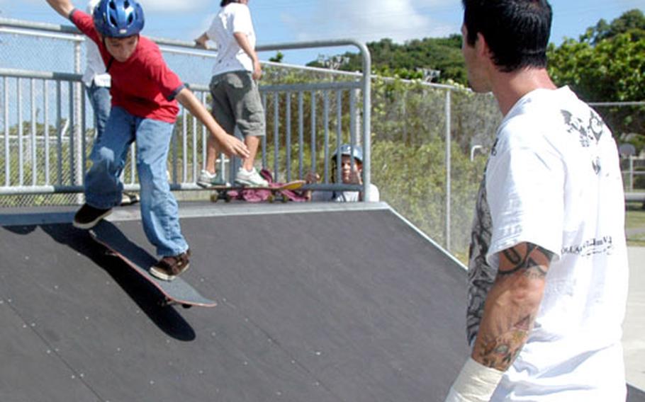 Professional skateboarder Chad Knight critiques young skaters&#39; technique as they roll down a ramp during a three-day skateboarding camp at Camp Courtney Tuesday.