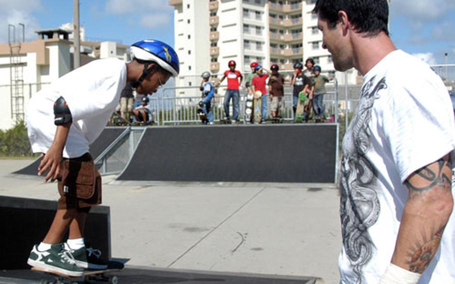 Dyrell Cole, 11, heads down a ramp with some direction from Chad Knight.