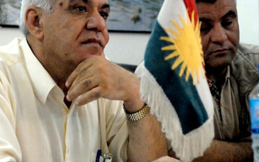 Samir Mohammad Noor, head of the city council in Khaniqin, Iraq, is seated next to a Kurdistan flag during a meeting Wednesday. Khaniqin is in Arab-dominated Diyala province, but most residents hope to some day join the Kurdistan Regional Government, which has created tensions with Diyala. The city council had an Iraqi flag, but it was about an inch shorter than the Kurdistan flag.