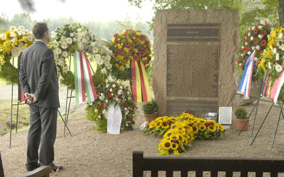 A man takes in the moment after the conclusion of a ceremony Thursday in remembrance of those who died 20 years prior in an air show crash at Ramstein Air Base. Three aircraft from Italy&#39;s precision-flying team Frecce Tricolori collided during an aerial maneuver killing 67 bystanders and injuring more than 500 others. The three Italian pilots also died in the disaster.