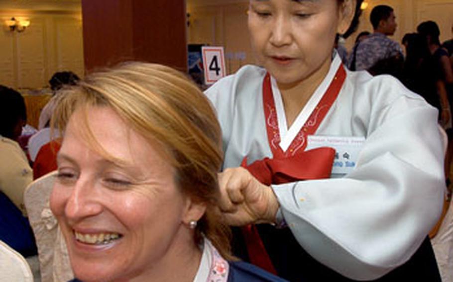 Deanna Young gets her hair done during a traditional Chuseok ceremony at the Yulim Hotel in Dongducheon, South Korea, on Thursday.