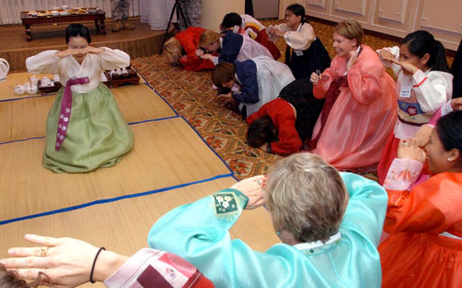 Camp Casey area employees and spouses learn Chuseok bowing etiquette at the Yulim Hotel in Dongducheon.