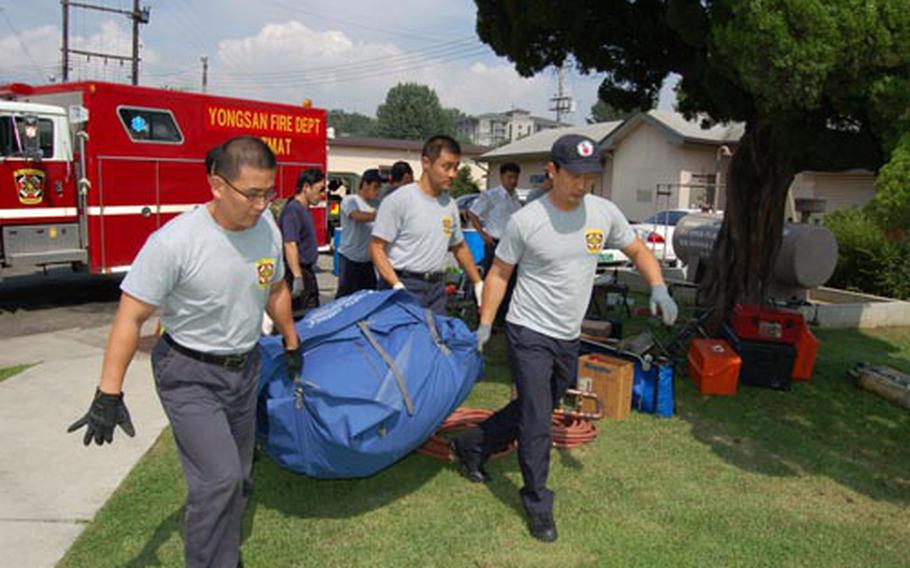 Firefighters from the U.S. Army Garrison Yongsan Fire Department prepare to set up a decontamination station during hazardous material training.