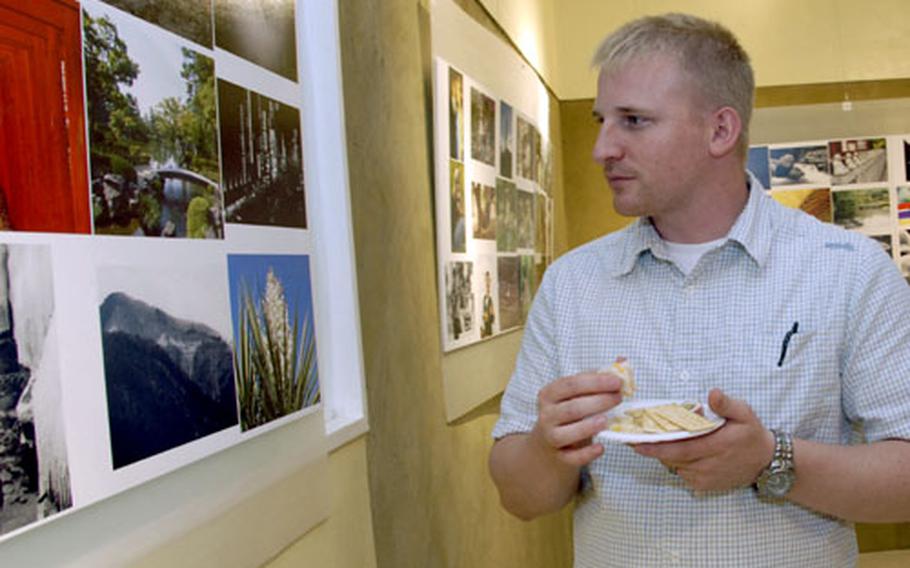 Stephan Gurian, who won the People&#39;s Choice award, checks out the contest photographs. Nearly 300 submissions will remain on display through October.