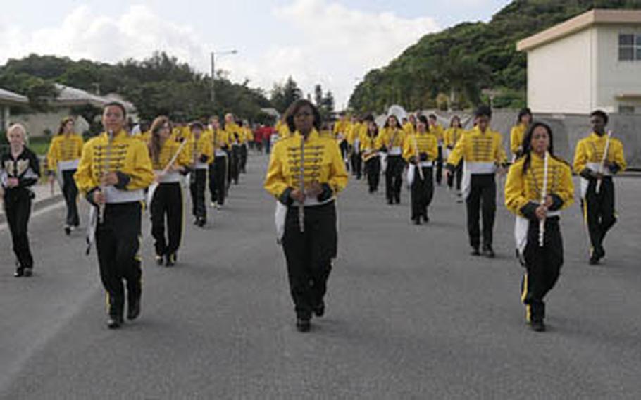 Kadena High School&#39;s new marching band marches at he head of Kadena Elementary School&#39;s Red Ribbon parade in one of the base&#39;s residential areas recently.