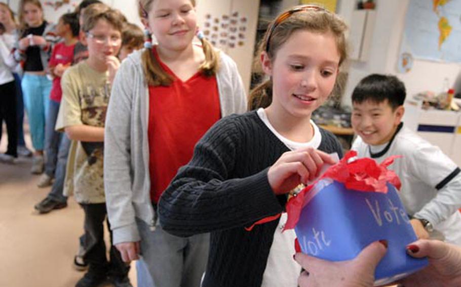 Emily Adams, a fifth-grader at Landstuhl Elementary School in Germany, casts her vote during a mock presidential election Tuesday at Landstuhl.