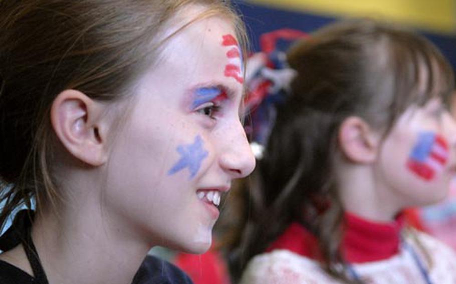 Fourth-grader Danniel Flaherty shows off her country&#39;s colors during a the mock presidential debate.