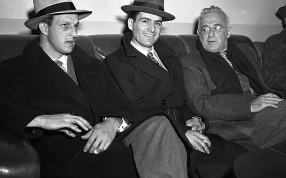 Frankfurt, Germany, February 4, 1951: Four of the baseball notables taking part in the week-long EUCOM Baseball and Softball Coaches and Officials clinic relax at Rhein-Main airport after a 27-hour flight from the States. From left to right are players Stan Musial of the St. Louis Cardinals and Jerry Coleman of the New York Yankees; and former Giants and Cardinals great Frankie Frisch.