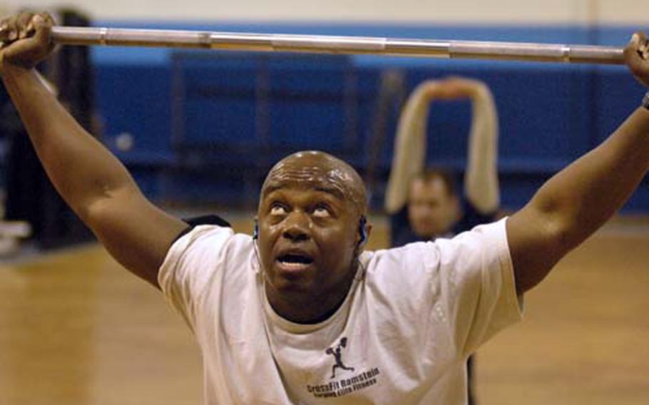 Tech. Sgt. James Johnson, an airman assigned to Ramstein Air Base’s First Term Airmen Center, eyes the 65 pounds that are trying to keep him down during a set of 15 squats.