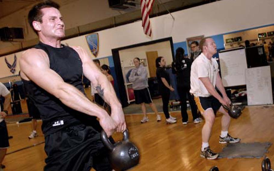 Airman 1st Class Dan Dutcavich from the 435th Medical Operations Squadron swings a 35 pound kettle bell over his head.