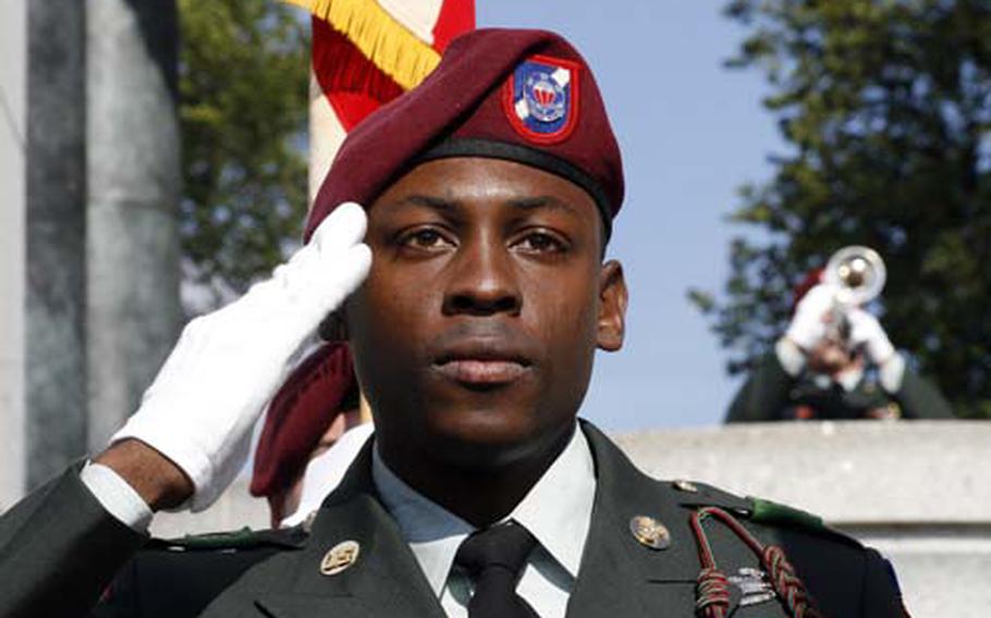 A soldier from the 82nd Airborne Support Battalion salutes during the playing of Taps on Veterans Day at the national World War II Memorial in Washington, D.C.