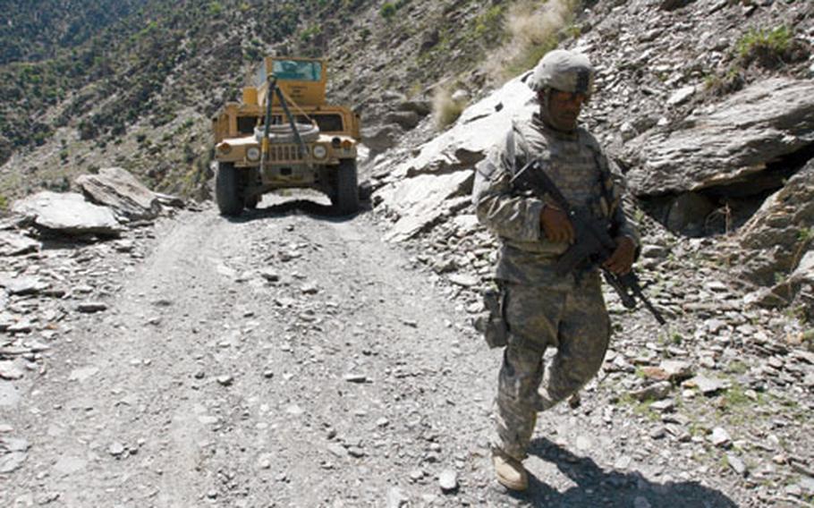 Staff Sgt. Antwane Mobley, 29, of Lancaster, S.C., walks ahead of a Humvee on a narrow mountain road near the Gowerdesh Brigde in Afghanistan’s Nuristan province in April 2008. A recent report by the Pentagon’s inspector general stated that the Army and Marine Corps have known its Humvees, like the one pictured, were "deathtraps," particularly when hit by roadside bombs or land mines, since the early 1990s.