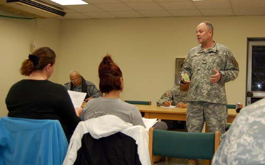 U.S. Army Garrison Yongsan commander Col. Dave Hall talks to Hannam Village residents during a town hall meeting Tuesday.