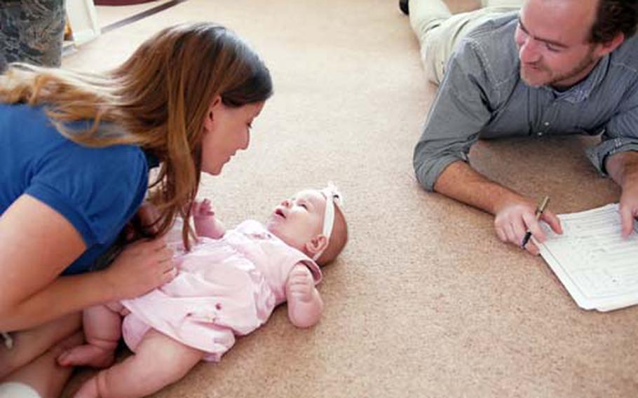 Wendy Funches plays with her youngest daughter, Eden, while discussing her development with Roy Fowler, an early childhood special needs educator with Education and Developmental Intervention Services. At 3 weeks old, Eden was diagnosed with coloboma, a rare eye disorder that left the child blind.