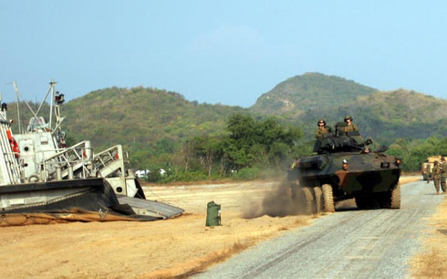 Marines and sailors with 3rd Battalion, 5th Marines, 31st Marine Expeditionary Unit offload Light Armored Vehicles from an LCAC hovercraft