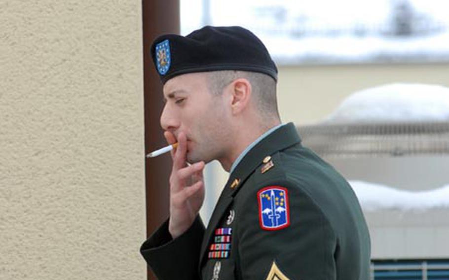 Sgt. Michael Leahy Jr. smokes a cigarette during a recess in his court-martial at Vilseck, Germany, for the alleged murder of detainees in Iraq.