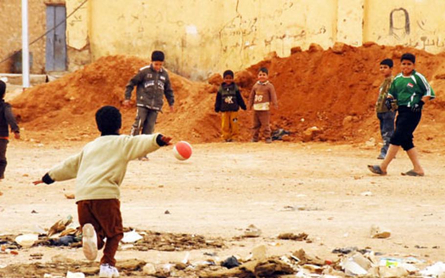 Children play soccer at an empty lot in Rutbah, Iraq, an area that until recently U.S. Marines say was like the Wild West in terms of lawlessness and violence.