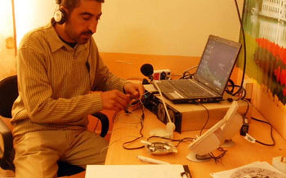 Disc jockey Salih Ahmah Hasoon listens to the radio on Friday, inside Rutbah Today, a radio station that U.S. forces helped start in December. The radio station broadcasts city council meetings, and Hasoon, the only DJ, interviews city officials, using questions that he gathers from people on the street.