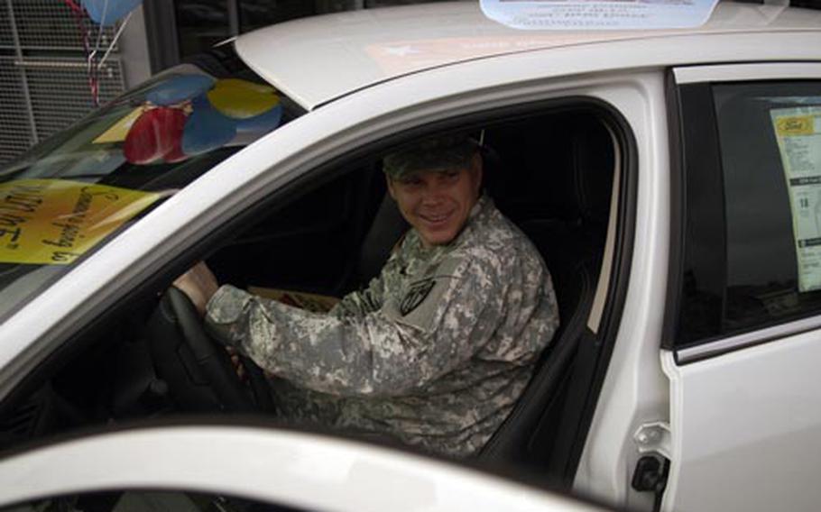 Staff Sgt. Britt Boyer of the 554th Military Police Company in Stuttgart, Germany, starts his new Ford Fusion, which he received in an Army and Air Force Exchange Service and Pizza Hut promotion. The car was given as a surprise to Boyer, who will be deploying to Afghanistan this spring.