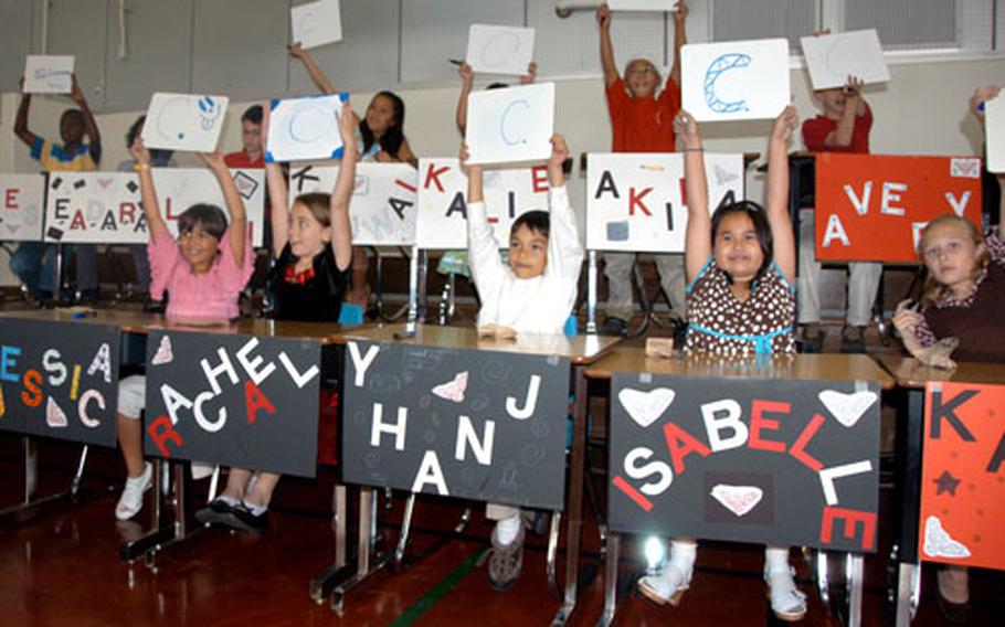 The participants in “Are you smarter than a Firebird?” display their answers to one of the questions asked during Thursday’s game.