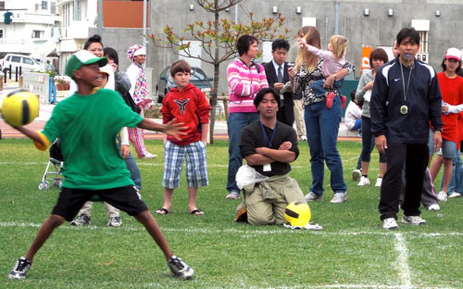 TyJon Cuffee, 11, a sixth-grader at Kadena Middle School, takes aim at the opposing team Saturday during a dodge-ball game between American and Japanese children during Saturday&#39;s Ichariba chode and Bilateral Friendship Day.