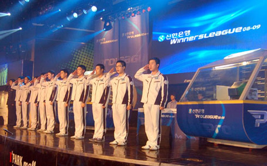 Members of the South Korean air force Ace Team salute a room full of cheering fans prior to a professional "StarCraft" match last month at e-Sports Stadium in Seoul.