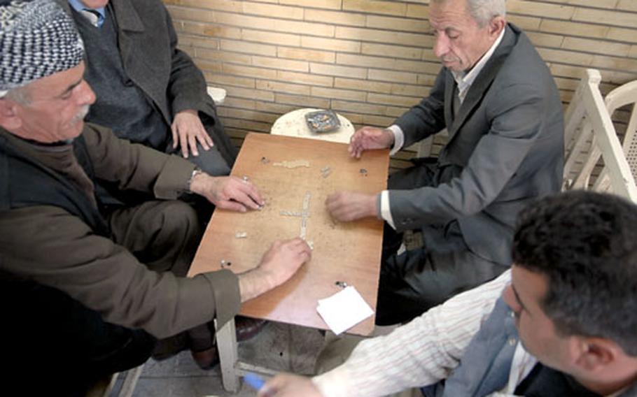 Men play dominoes at one of Irbil’s ubiquitous tea shops, many abuzz with political chatter. Many Kurds say they are deeply concerned about their future and are critical of both the Arab-dominated central government and Kurdistan’s semi-autonomous regional government.