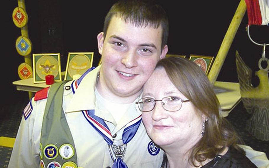Cliff Carlson, 18, poses with his mom, Cindy, after becoming an Eagle Scout.