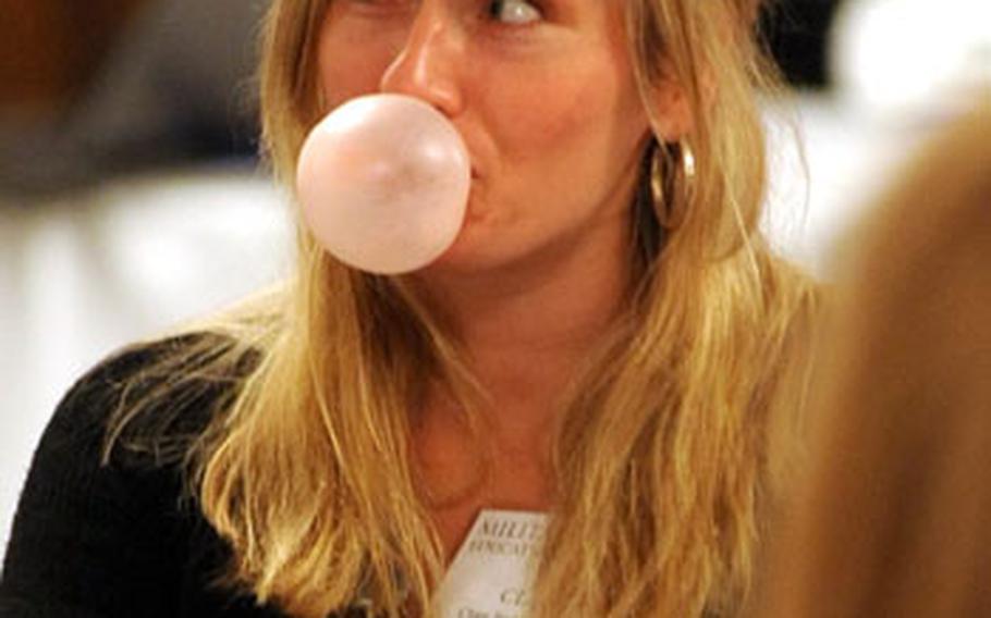 Clare Barnard-Schmitz, a DODDS psychologist in Germany, blows a bubble during a training session describing how bubble gum can be used to calm an anxious child.