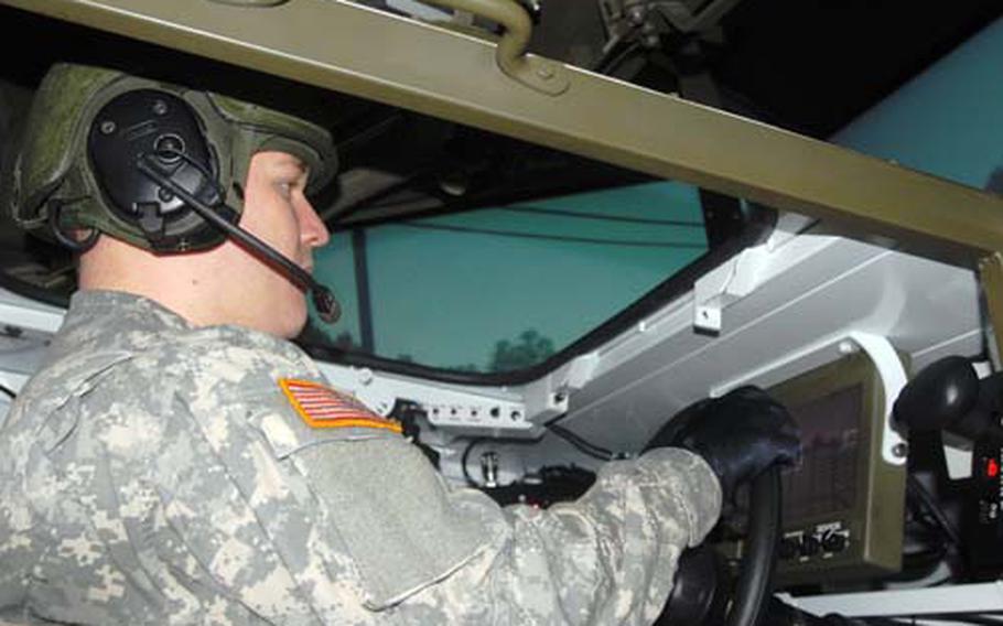 Spc. Joshua Ballenger, 24, of The Colony, Texas, drives a Stryker simulator at Vilseck, Germany, on Wednesday. The simulator allows soldiers to practice driving a vehicle before actually getting behind the wheel and heading out on the road.