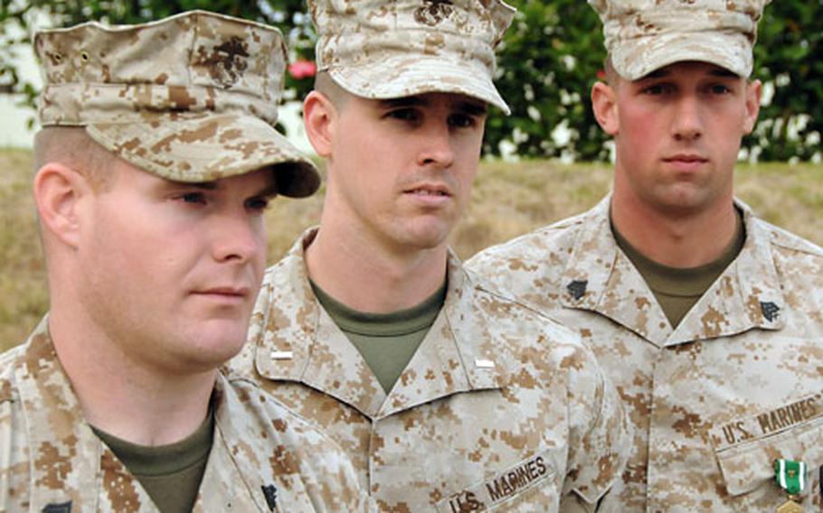 From left, Cpl. Jason D. Jones was awarded a Silver Star; 1st Lt. Christopher J. Kearney was awarded a Bronze Star with “V” for valor; and Sgt. Norman J. Era was awarded a Navy and Marine Corps Commendation Medal with a “V” device during a ceremony at Camp Schwab, Okinawa, on Thursday. The Marines, all with the 4th Marine Regiment, were recognized for their actions in Afghanistan.