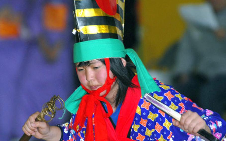 A young Japanese girl performs a traditional dance.