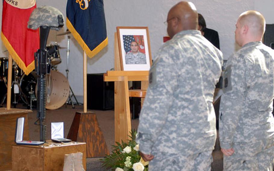 Two soldiers pay their respects following a memorial ceremony at Ledward chapel on Ledward Barracks in Schweinfurt, Germany, for Sgt. Jose Escobedo Jr., 32, who died from injuries sustained in a non-combat related incident March 20 in Iraq.