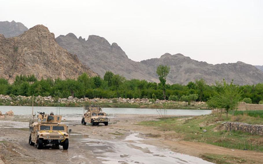 Humvees cross the Bud-E Arghandab River.