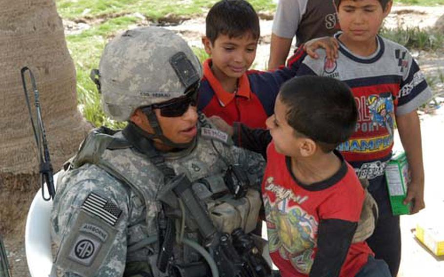 In Baghdad’s Fadhil neighborhood, Staff Sgt. Damian Remijio of the 5th Squadron, 73rd U.S. Cavalry Regiment clowns it up with some local kids.