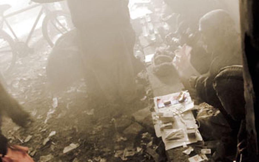 Dozens of men sit inside a smoke-filled room while using drugs in Kabul. Addicts said it costs about 120 Afghanis, or roughly $2.50, to buy a fix.