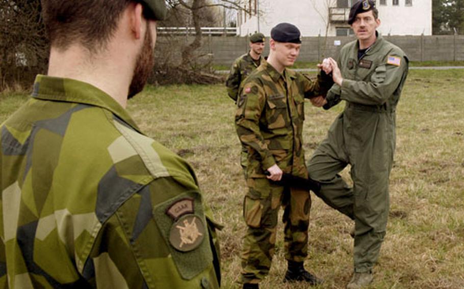 Master Sgt. Frank Prebble gives instruction to Swedish and Norwegian members of the Heavy Airlift Wing’s Raven Team. The Ravens are the security element for the C-17 crew, securing the areas around the plane upon landing. Most of the training, however, focuses on communication skills and using “verbal judo” to resolve disputes that may occur in potentially hostile places.