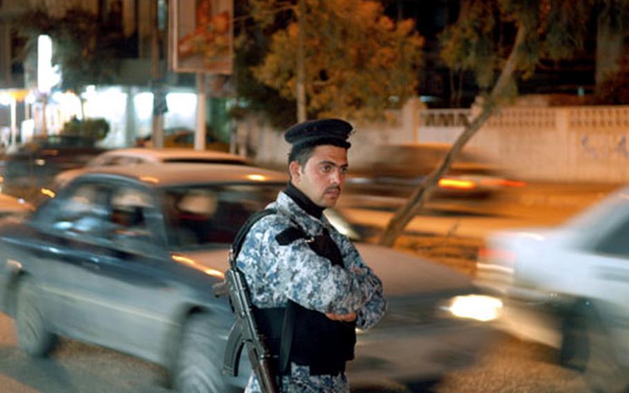 An Iraqi policeman stands guard last month in Kirkuk city. While police are plentiful in Kirkuk province&#39;s northern areas, the south is noticeably absent of police stations, making it prime territory for insurgents, according to U.S. commanders.