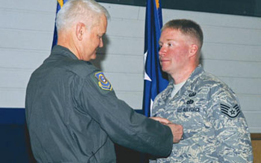 In March 2008, Lt. Gen. Robert D. Bishop Jr., then 3rd Air Force commander, left, presents Myers with a Bronze Star Medal during an Airmen’s Call at RAF Lakenheath. Myers, 30, of Hopewell, Va., died April 4 in Afghanistan.
